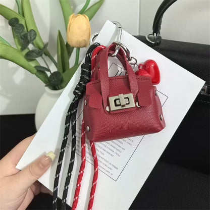 Creative miu is a personalized mini leather pouch keychain, headphone bag, accessories, keychain, school bag, pendant