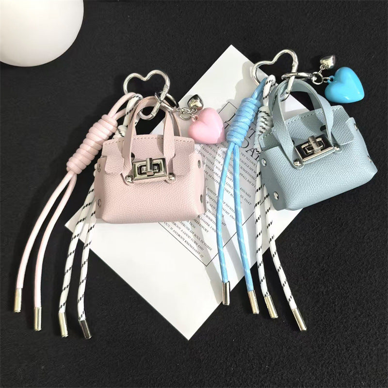 Creative miu is a personalized mini leather pouch keychain, headphone bag, accessories, keychain, school bag, pendant