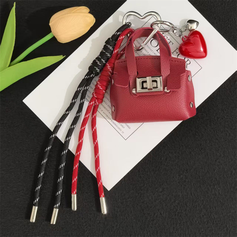 Creative miu is a personalized mini leather pouch keychain, headphone bag, accessories, keychain, school bag, pendant
