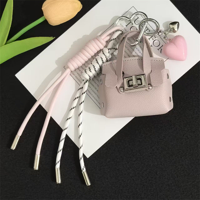 Creative miu is a personalized mini leather pouch keychain, headphone bag, accessories, keychain, school bag, pendant