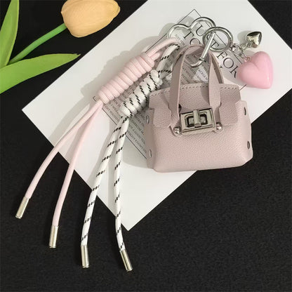 Creative miu is a personalized mini leather pouch keychain, headphone bag, accessories, keychain, school bag, pendant